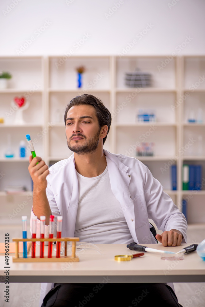Young male chemist working at the lab Young male chemist working at the lab