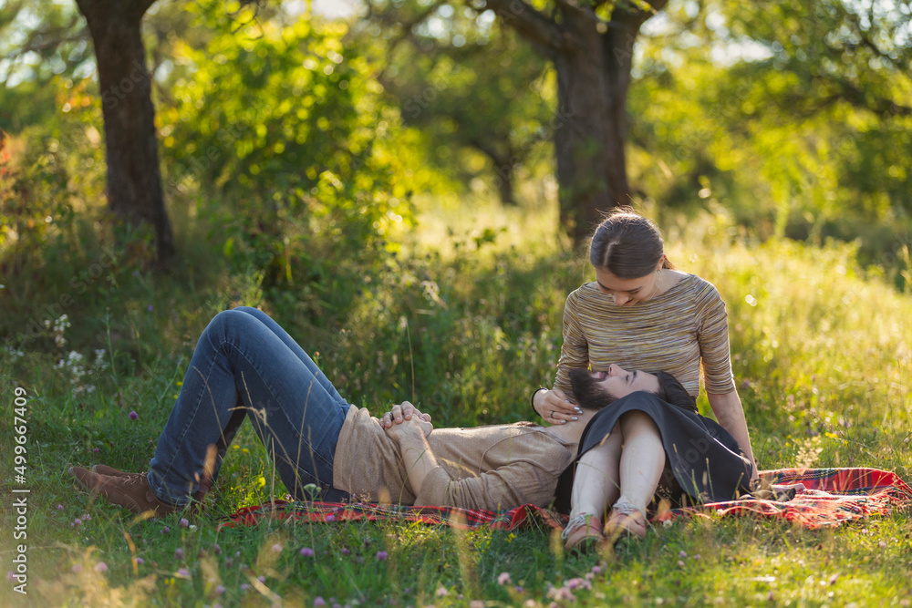 young couple sitting in nature and relaxing