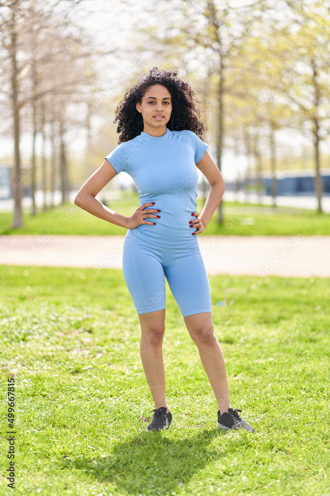 Portrait of beautiful fit girl, young slim fitness sports woman in sportswear, top outdoors going to training Portrait of beautiful fit girl, young slim fitness sports woman in sportswear, top outdoors going to training