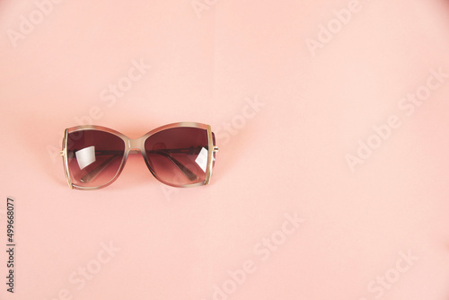 woman sunglasses on the pink table