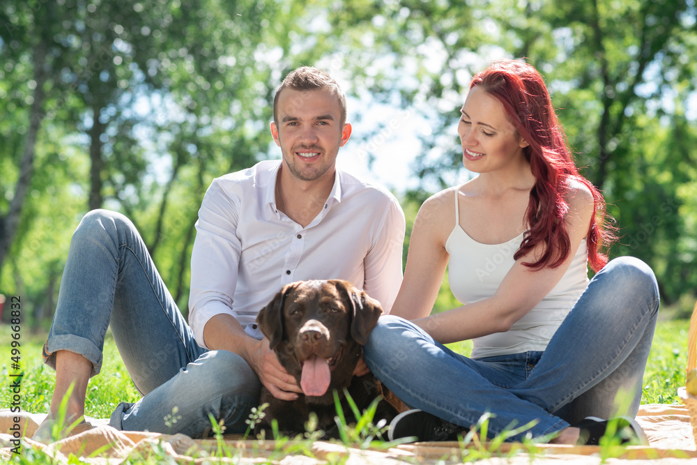 Fototapeta premium Couple with a dog in the park