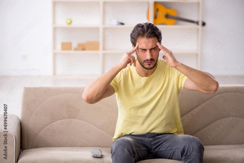 Young man sitting at home during pandemic Young man sitting at home during pandemic