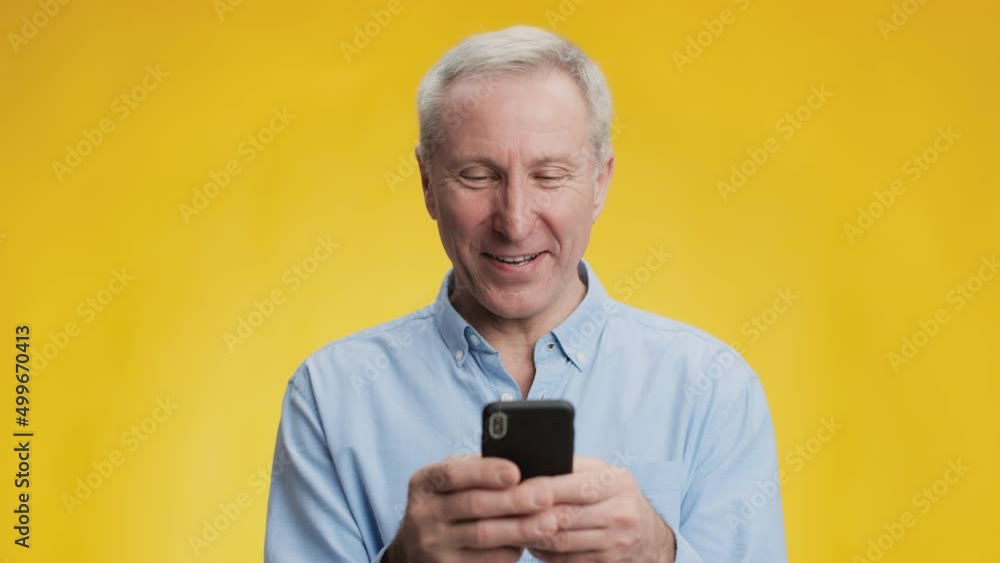 Social media for senior people. Happy interested grey-haired man networking online on smartphone, chatting in internet Social media for senior people. Happy interested grey-haired man networking online on smartphone, chatting in internet