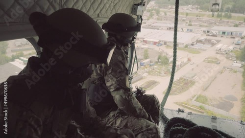 War between Ukraine and Russia. Military operations in Ukraine. Soldiers fly in a helicopter, performing a military special mission