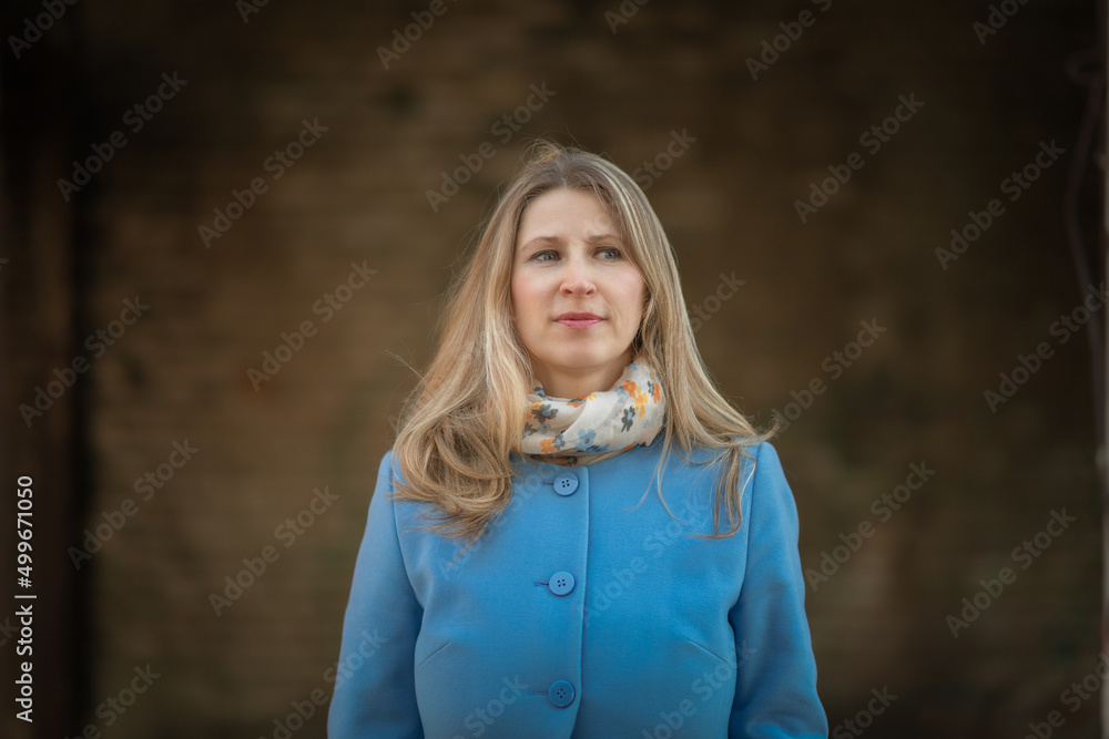 Portrait of a young beautiful girl in a blue coat at the end of summer. Portrait of a young beautiful girl in a blue coat at the end of summer.