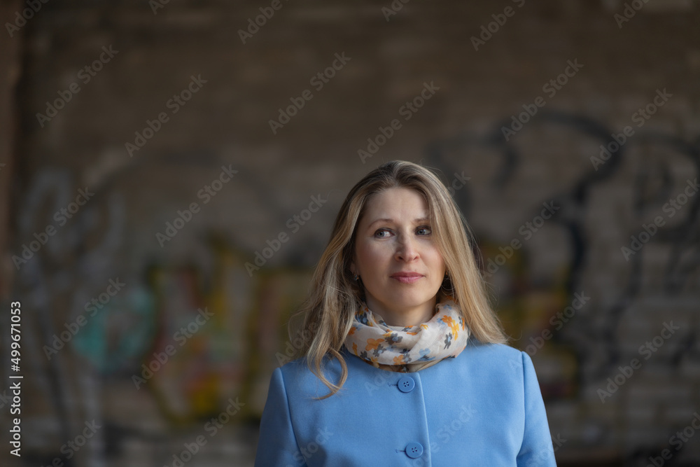 Portrait of a young beautiful girl in a blue coat at the end of summer. Portrait of a young beautiful girl in a blue coat at the end of summer.