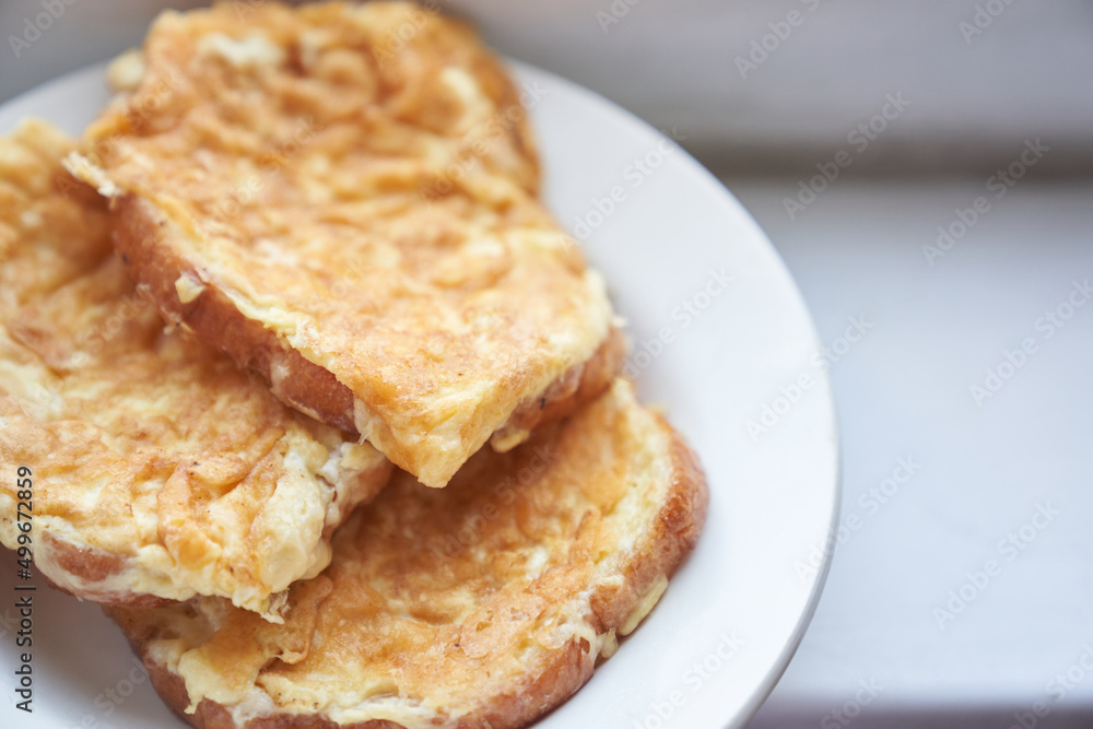 Close-up of delicious egg sandwiches in a white plate. The concept of a quick breakfast