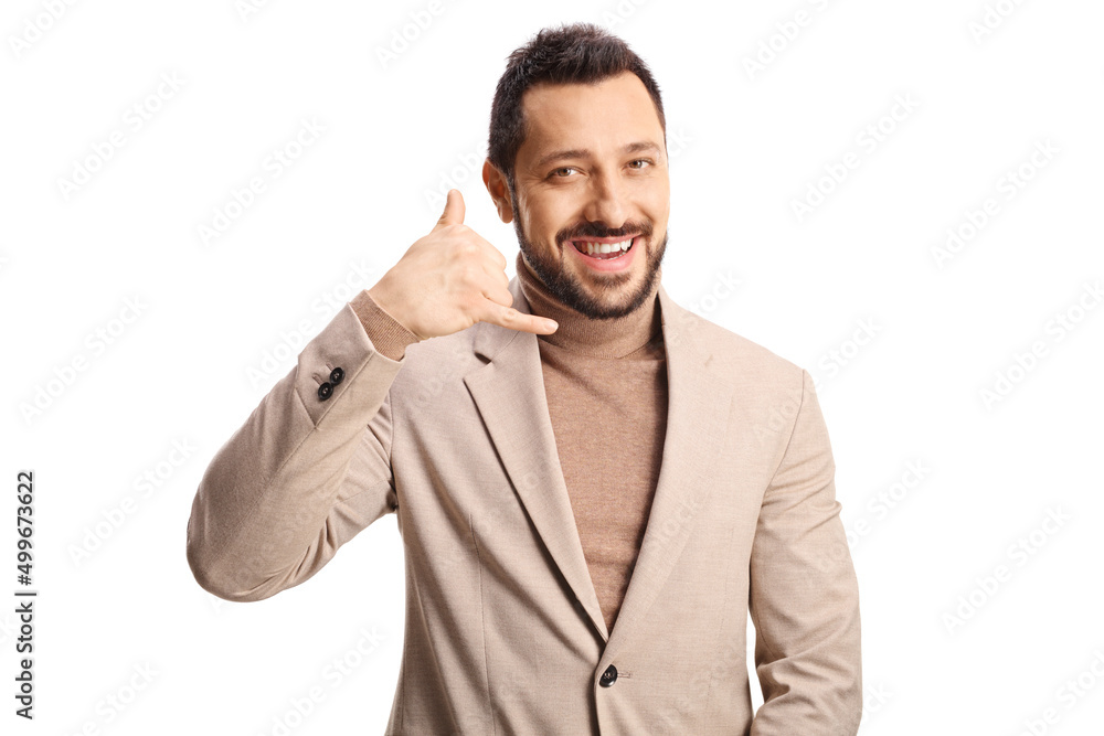 Smiling young handsome man making a phone call sign Smiling young handsome man making a phone call sign