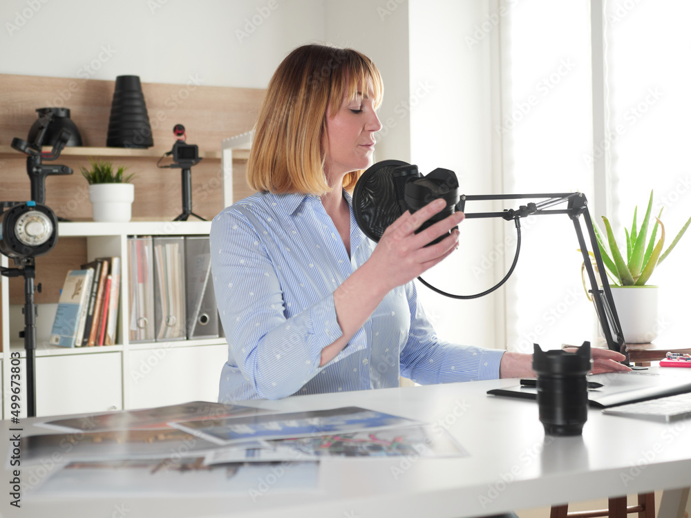 Female photographer talking about new lenses on video blog Female photographer talking about new lenses on video blog