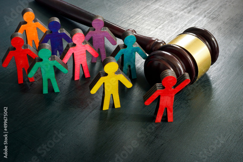 Figurines and gavel. Equality and social advocacy concept. photo