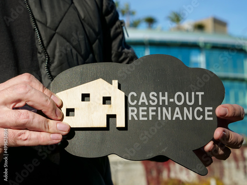 Plate with house and cash out refinance sign. photo