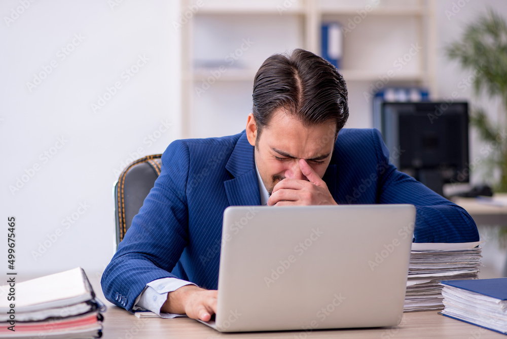 Young male employee working in the office Young male employee working in the office