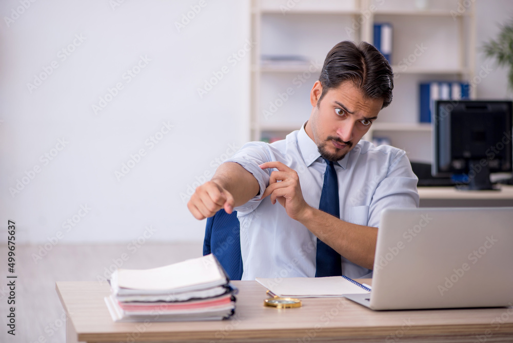Young male employee working in the office Young male employee working in the office