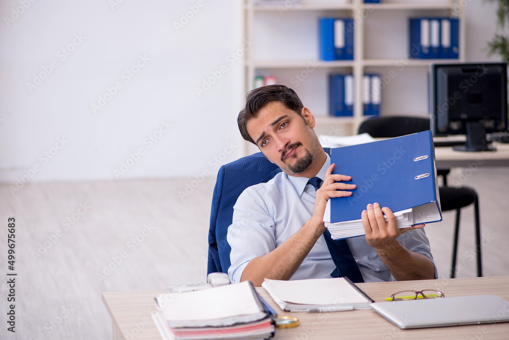 Young male employee working in the office Young male employee working in the office