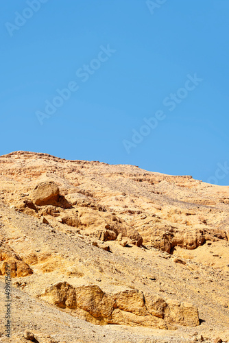 Desert landscape in Egypt. View of sandy hill against clear blue sky. Copy space for text. Vertical photo. Selective focus.