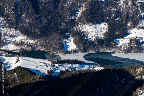 Scenic view from the summit of mount Hochobir on the frozen lake of Freibacher Stausee s in the Karawanks in Carinthia, Austria. Winter wonderland on sunny day in Austrian Alps, Europe