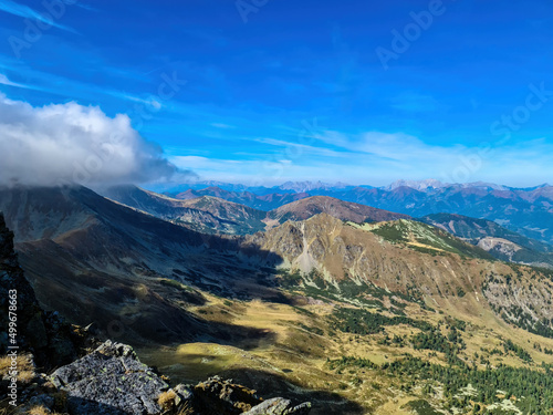 Panoramic view from Seckauer Zinken in the Lower Tauern mountain range, Styria, Austria, Europe. Eisenerz Alps in the distance. Sunny autumn day in the Seckau Alps. Bare, rocky terrain. Clouds coming