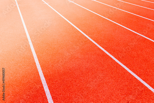 Red treadmill on sport field. Running track on the stadium © ALEXSTUDIO