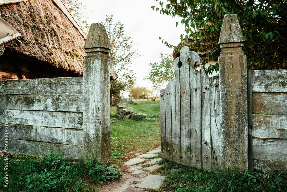 semi-open gray ancient wooden fence overlooking the courtyard of the old Ukrainian village 1 semi-open gray ancient wooden fence overlooking the courtyard of the old Ukrainian village 1