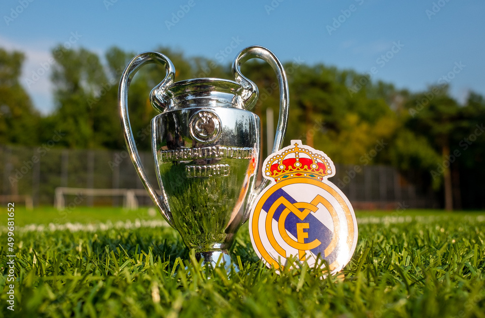 August 30, 2021, Madrid, Spain. The emblem of the football Real Madrid CF  and the UEFA Champions League Cup on the green turf of the stadium.  Stock-Foto | Adobe Stock