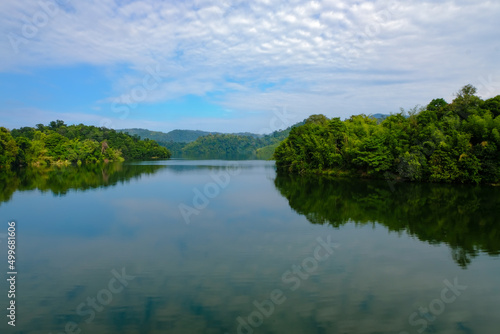 Calm view of dam water surrounded with green trees in Kuala Kubu Bharu  Selangor  Malaysia.