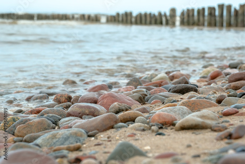 relaxation at sea. Stack of stones on beach. Stone cairn on natural background - blurred sea and sky. Concept balance