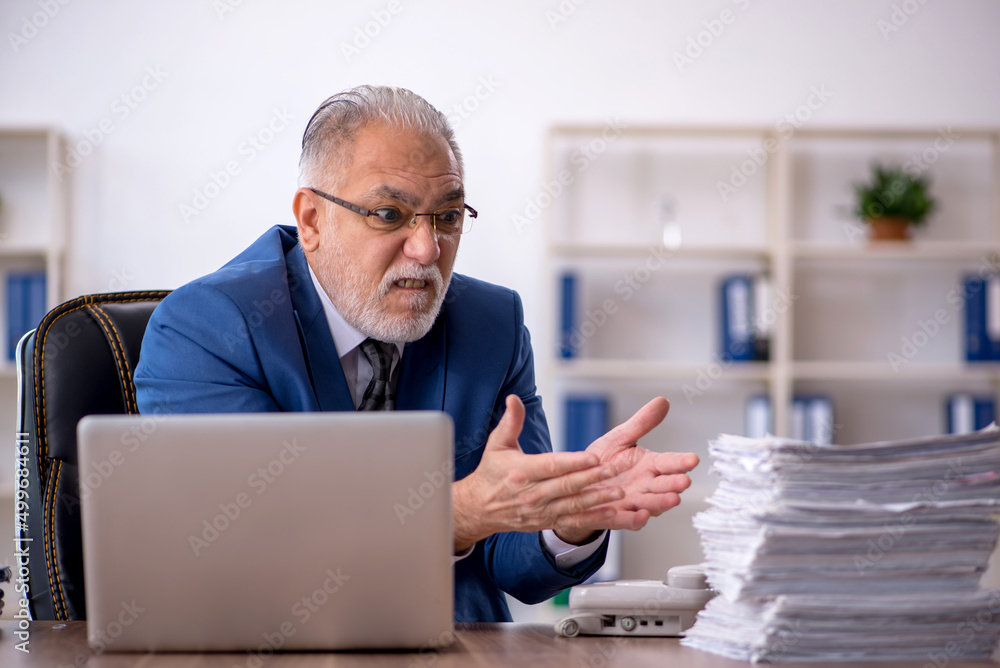 Old male employee and too much work in the office Old male employee and too much work in the office