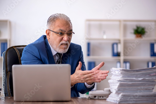Wallpaper Mural Old male employee and too much work in the office Torontodigital.ca