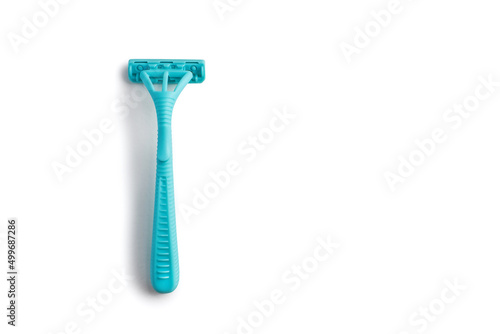 Disposable plastic razor on a white isolated background. Blue women's razor with free space for text on a white background. Skin care razor and neat look concept