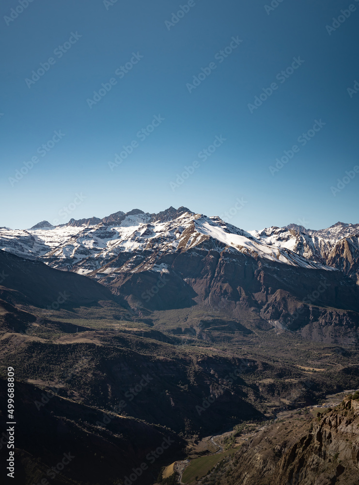 Vertical panoramic view of snow-capped mountain range in Cajon del Maipo, Chile