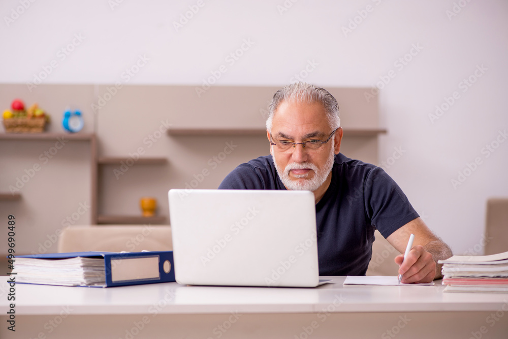 Old male employee working from home during pandemic Old male employee working from home during pandemic