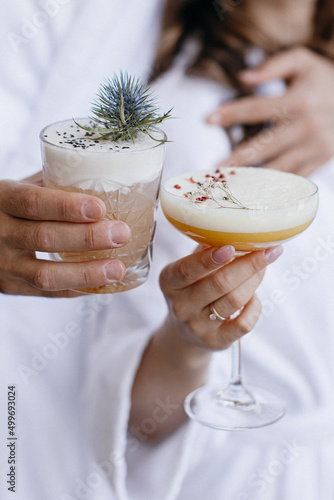 Cocktails in a glass in human hands 
