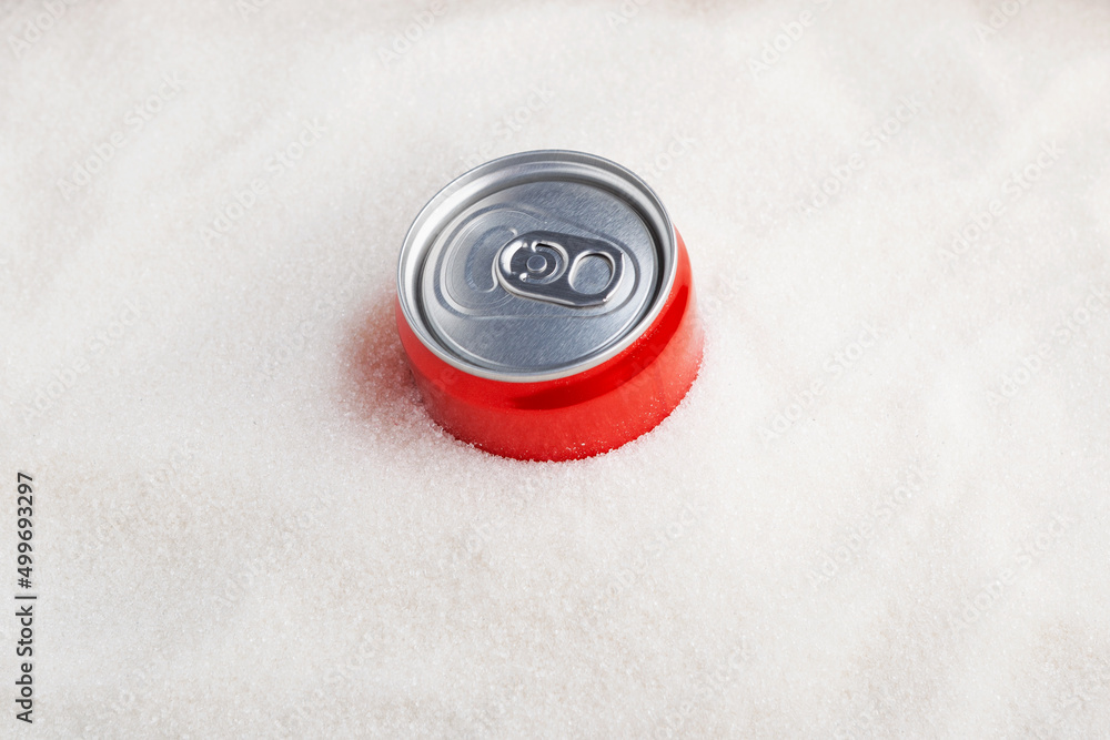 White refined sugar and Red can with sweet carbonated drink. Top view, copy space. Concept - Excess Sugar in Soda White refined sugar and Red can with sweet carbonated drink. Top view, copy space. Concept - Excess Sugar in Soda