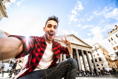 Happy tourist visiting Rome, Italy - Young man taking selfie in front of Pantheon, Italian landmark - Tourism and travel concept
