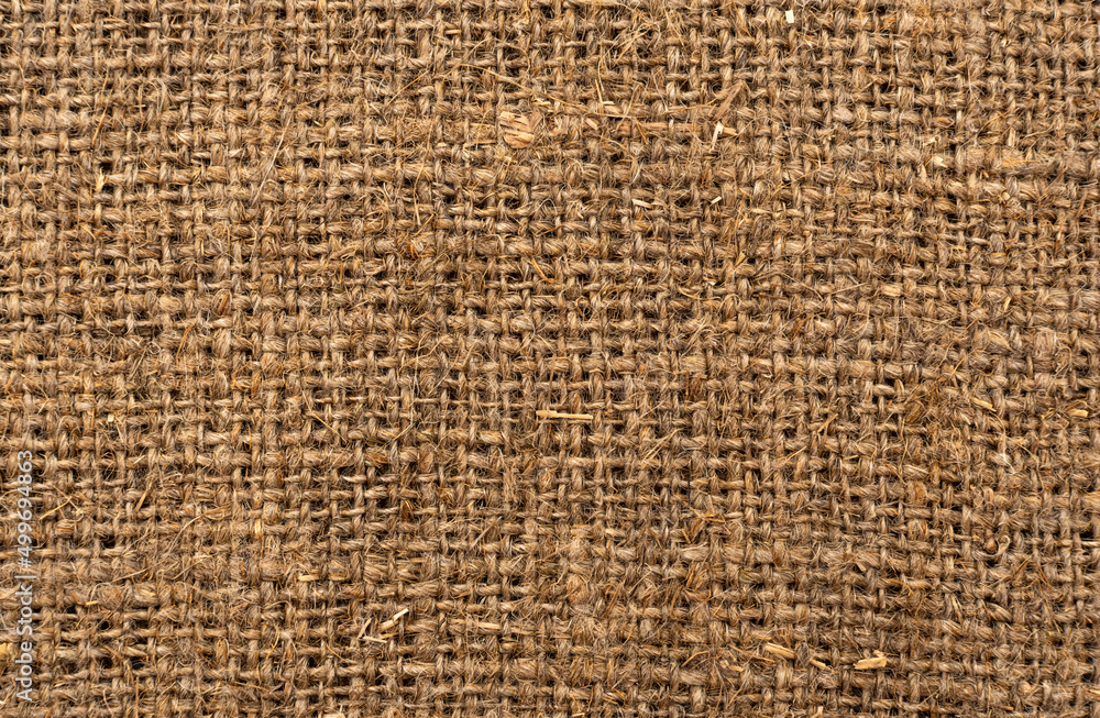 Cloth. The texture of the burlap fabric is close-up. Packaging material. Background Of Burlap Hessian Sacking Cloth. The texture of the burlap fabric is close-up. Packaging material. Background Of Burlap Hessian Sacking