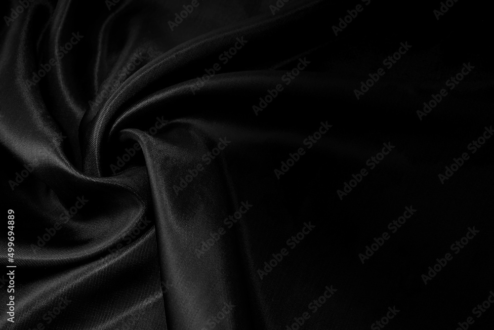 Obraz premium Part of the dark fabric texture of the fabric for the background and decoration of the work of art, a beautiful crumpled pattern of silk or linen. A crumpled piece of cloth