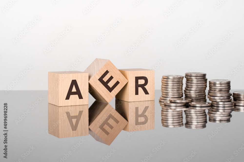 AER - the text is made up of letters on wooden cubes lying on a mirror surface AER - the text is made up of letters on wooden cubes lying on a mirror surface