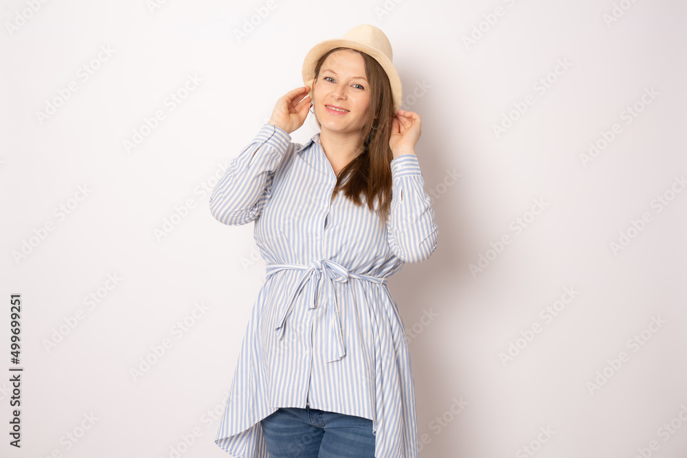 portrait of happy pregnant woman wearing straw hat isolated on white background. portrait of happy pregnant woman wearing straw hat isolated on white background.