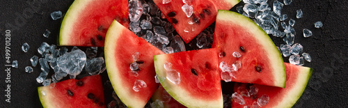 Flat lay top view watermelon with ice on black background. Sliced fruit with seeds