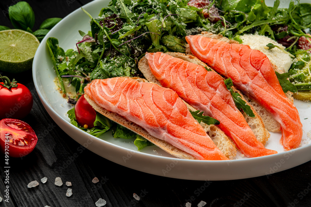 Salted salmon on croutons with fresh salad and cream cheese