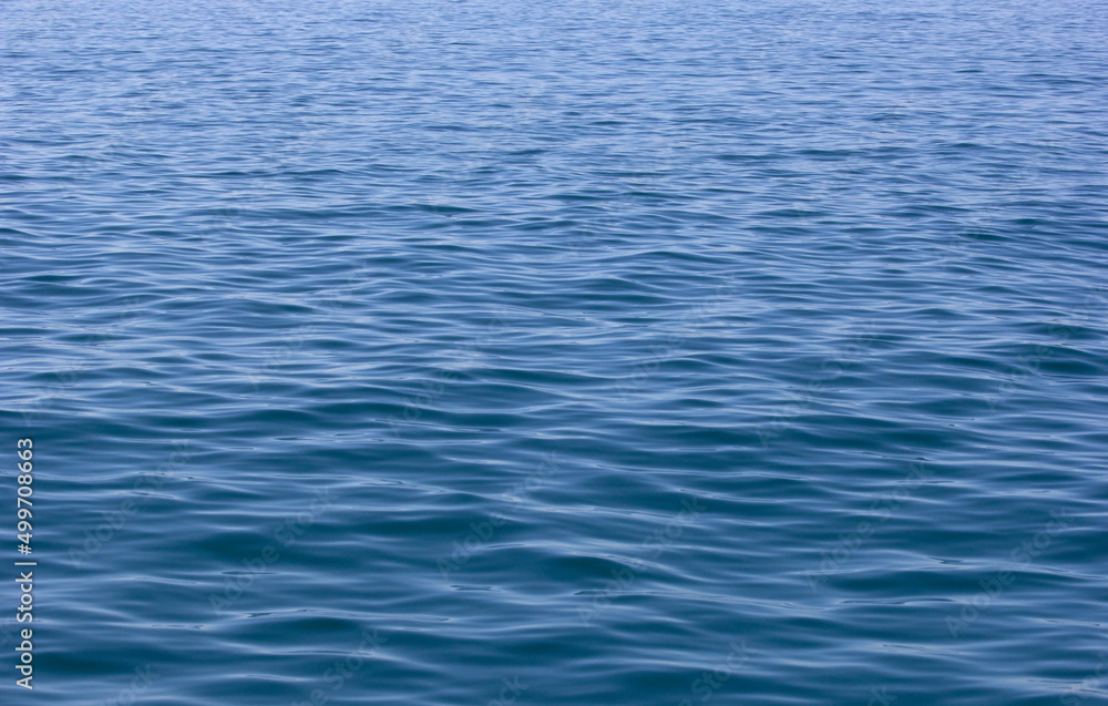 Water texture. Ocean, lake, river, open sea, high seas. Image that conveys peace, tranquility, serenity. Blue, light and shadow. Backdrop, background. Wallpaper. Water texture. Ocean, lake, river, open sea, high seas. Image that conveys peace, tranquility, serenity. Blue, light and shadow. Backdrop, background. Wallpaper.