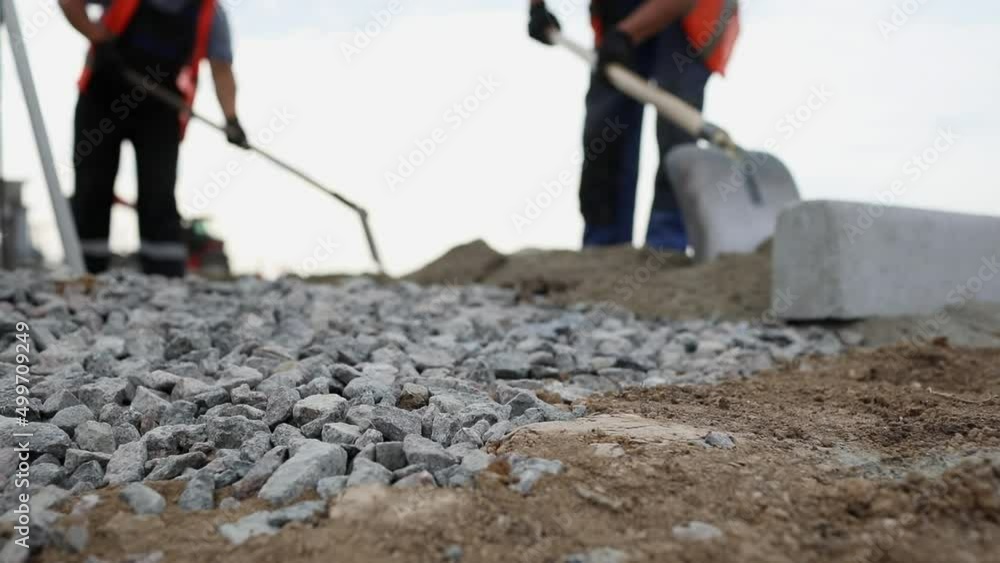 Handymen dig trench for laying power cables underground in duct ...