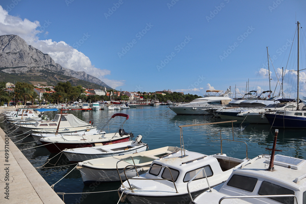 Boats and yachts in the port of the resort town of Baska Voda on a sunny summer day, Dalmatia, Croatia