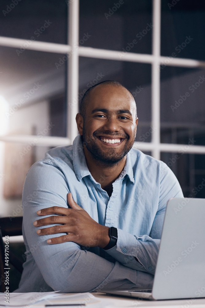 Putting in the hours to gain the results. Shot of a young businessman working on his laptop at night. Putting in the hours to gain the results. Shot of a young businessman working on his laptop at night.