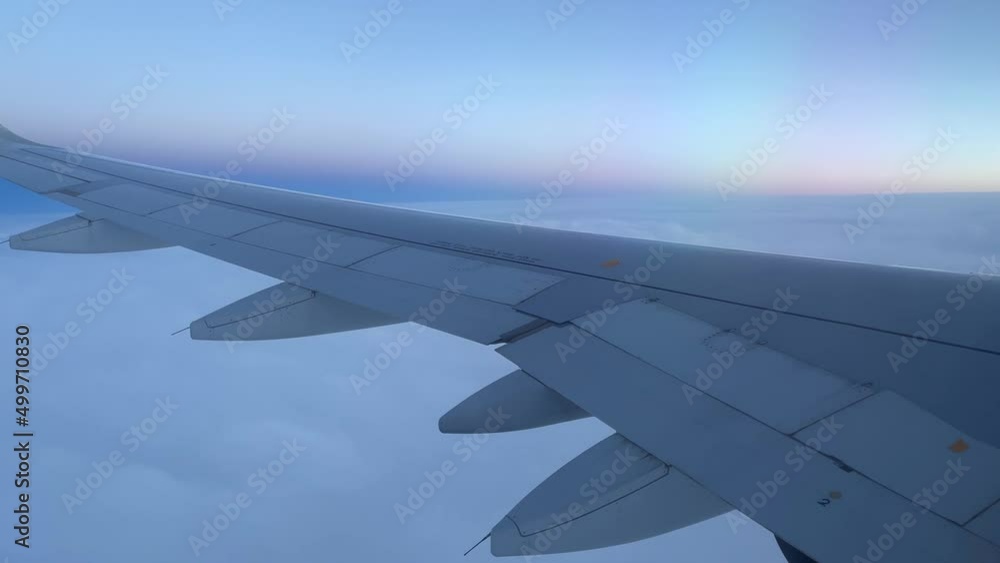 View from airplane window of horizon at blue sunset over clouds. Travel, air transportation concepts View from airplane window of horizon at blue sunset over clouds. Travel, air transportation concepts