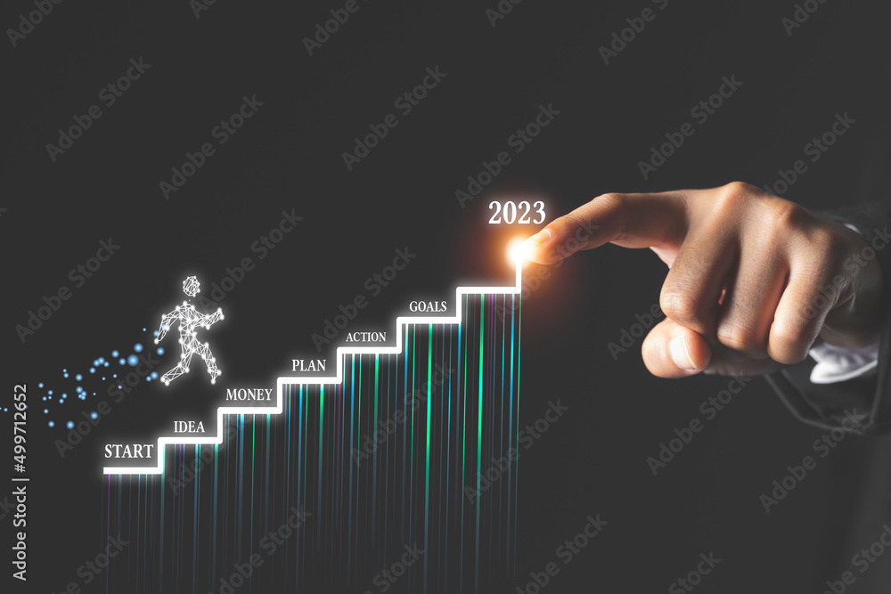 Businessman points his hand on an stairs with high growth rates in 2023 Businessman points his hand on an stairs with high growth rates in 2023