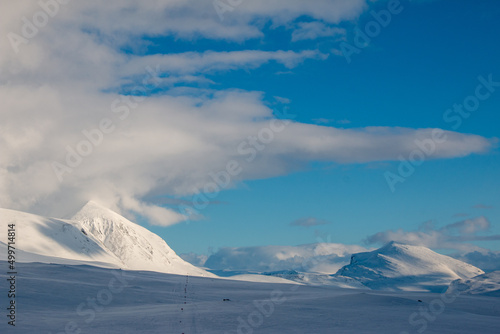 The view of Kungsleden trail from Salka hut at sunset during the winter season, April, Sweden photo