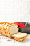 Sliced and fresh sandwich bread. Bread pan. White
