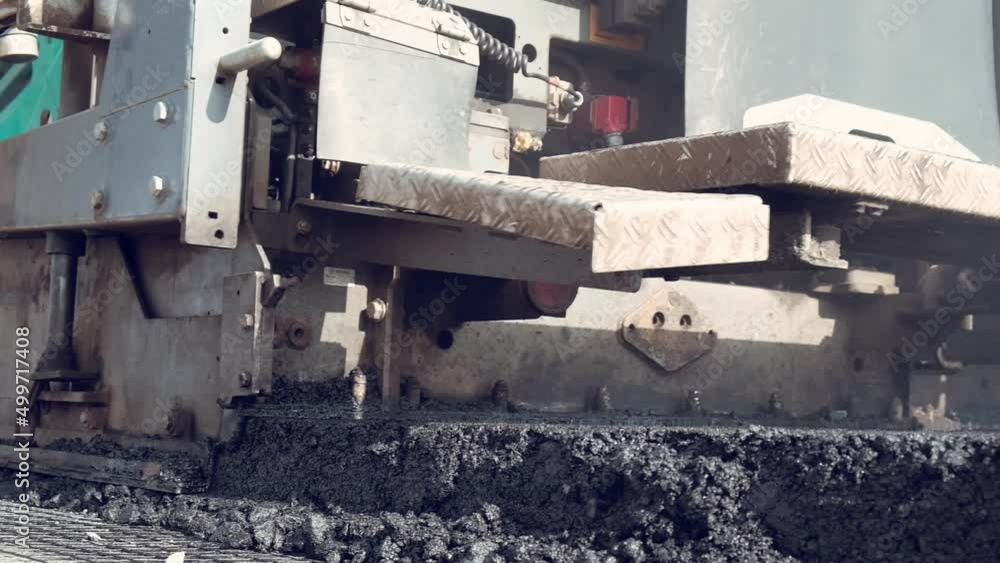 laying asphalt on the road. Road works on the track. highway and bridge construction.

