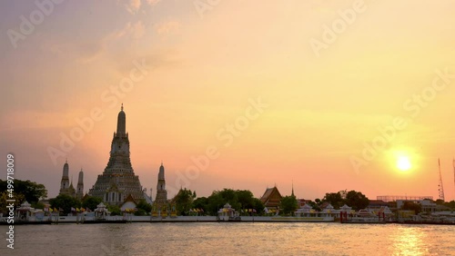 Wat Arun Ratchawararam (Temple of Dawn) and five pagodas during twilight sunset, This is the famous tourist destination in Bangkok, Thailand; Presented in time lapse with copy space for footage title.
